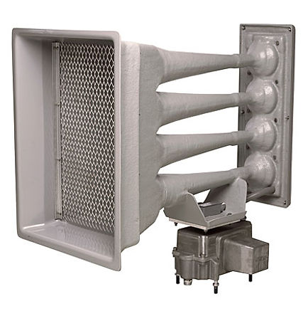 An industrial outdoor warning siren featuring four horizontally aligned acoustic projector horns mounted to a rectangular backplate. The horns are made of metal or fiberglass and converge at the rear where they are connected to a control box and motorized mechanism. The front of the siren has a large rectangular opening with a protective metal mesh grille. The design indicates it is intended for long-range sound projection, such as for tornado warnings or other emergency alerts.