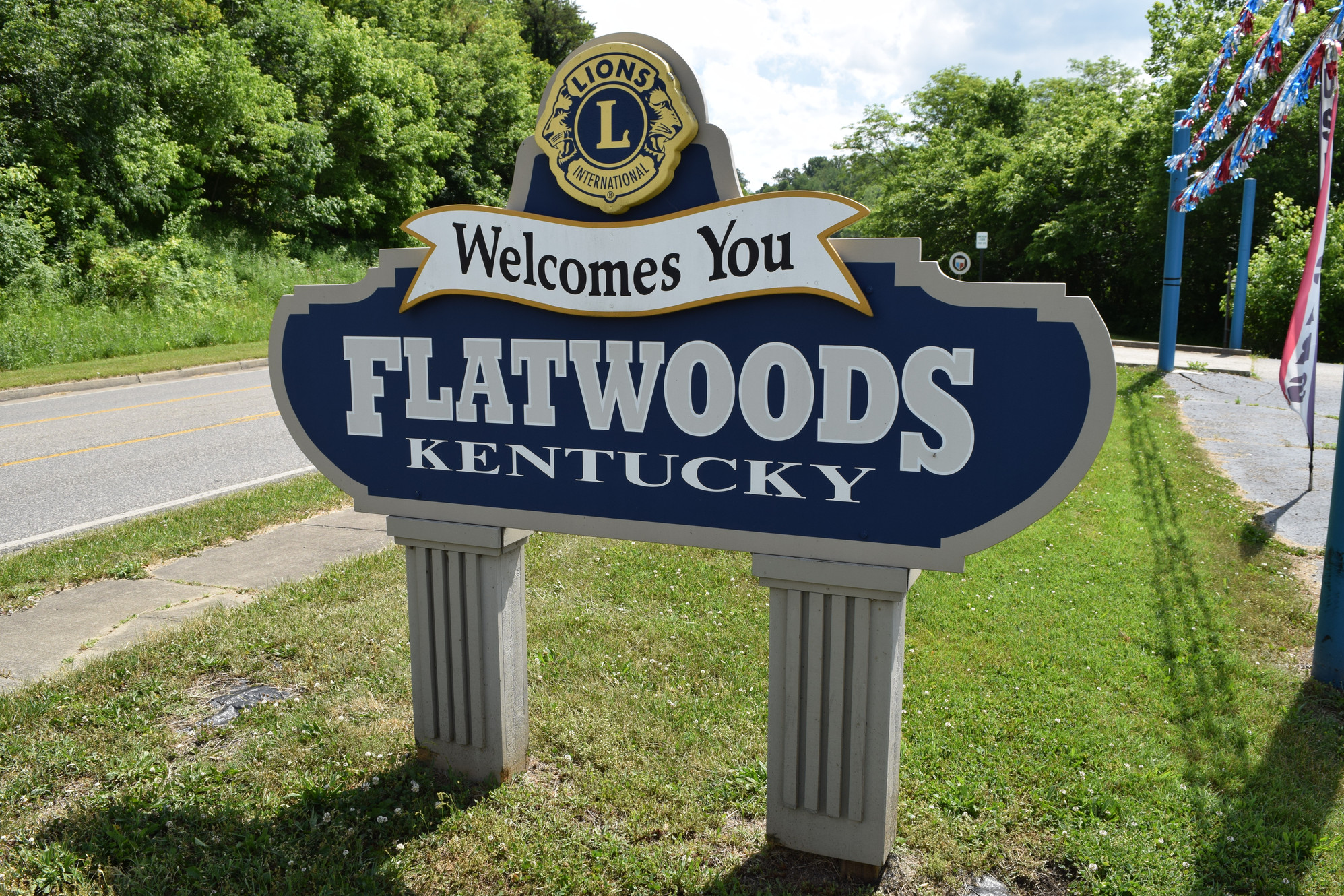 Flatwoods Welcomes You sign with city name